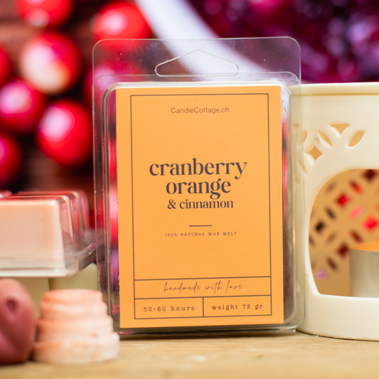 Cranberry Orange & Cinnamon wax melts in cozy, festive setting.